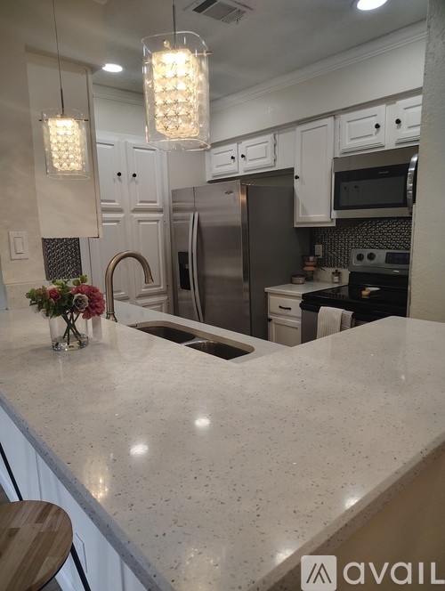 A kitchen with a granite countertop and a sink.