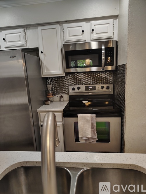 A kitchen with a stainless steel refrigerator and oven.