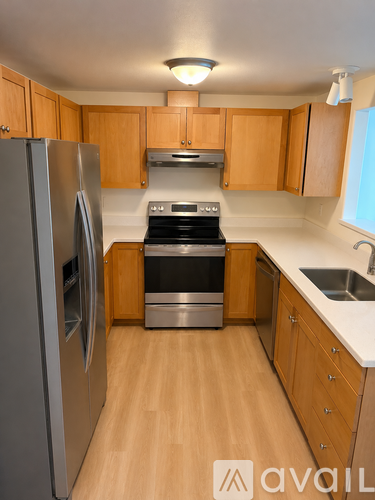 A kitchen with wooden cabinets and stainless steel appliances.