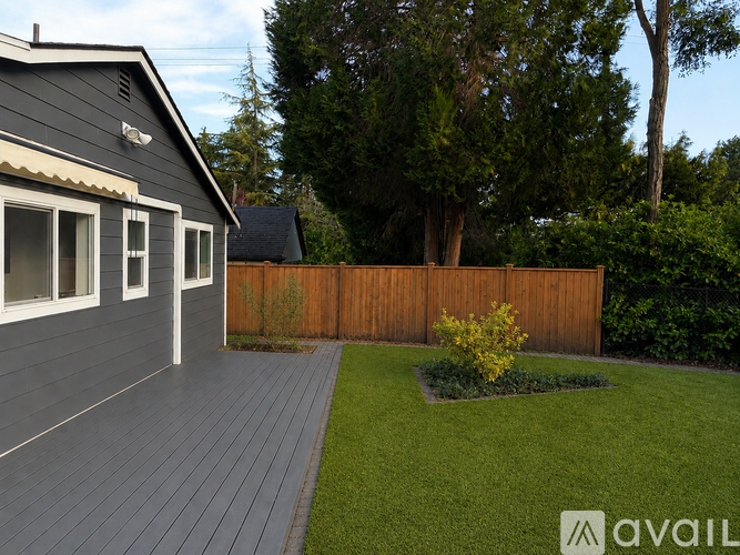 A house with a grey exterior and a wooden deck.