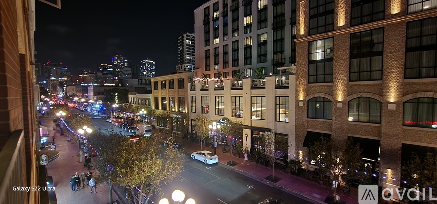 A city street at night with cars and buildings.