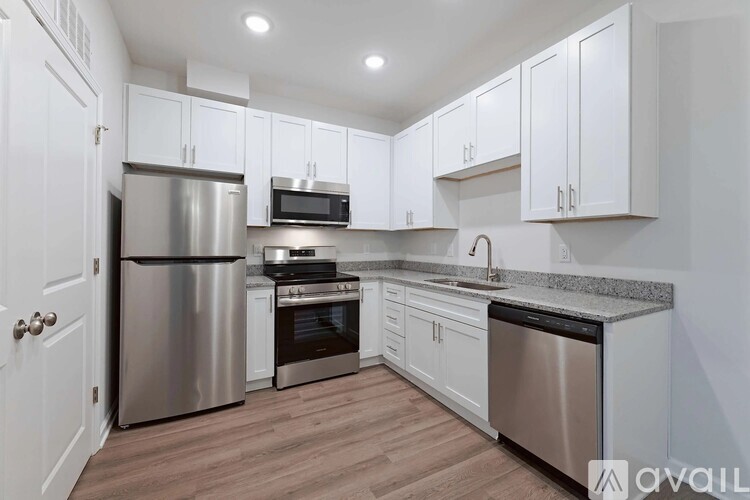 A kitchen with white cabinets and stainless steel appliances.