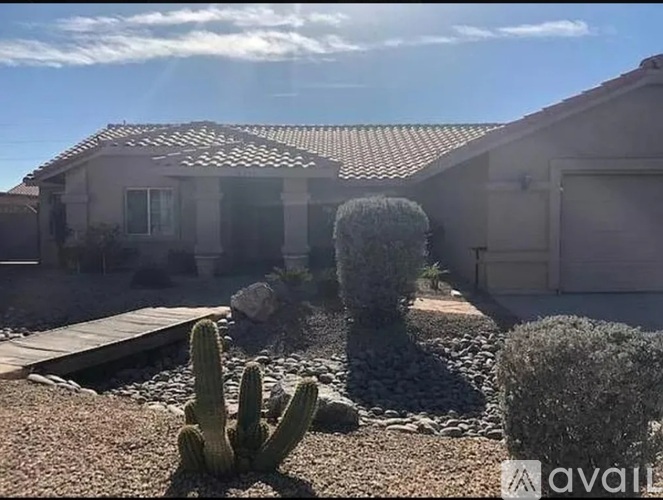 A house with a cactus in front of it.