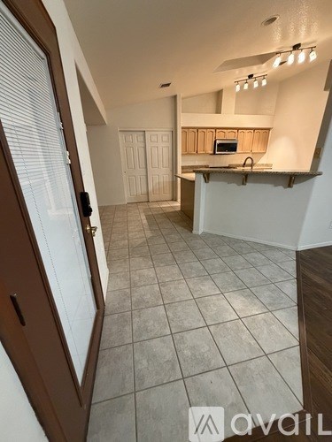 A kitchen area with a counter and a microwave.