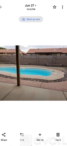 A pool surrounded by a fence.