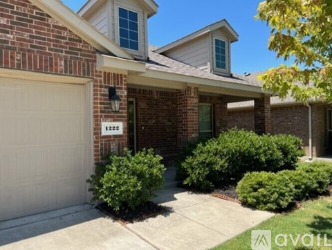 A house with a brick facade and a white garage door.