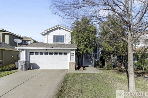 A house with a white garage door is for sale.