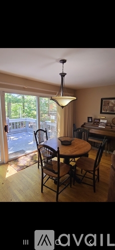 A dining room with a round table and chairs.