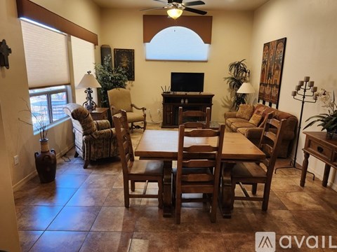 A living room with a wooden table and chairs.