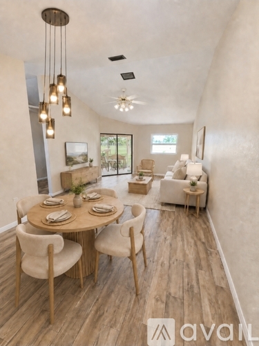 A dining room with a round table and chairs.