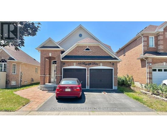 A red car is parked in front of a house with a garage.