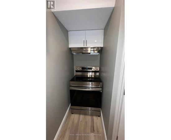 A small kitchen with a stainless steel oven and microwave.