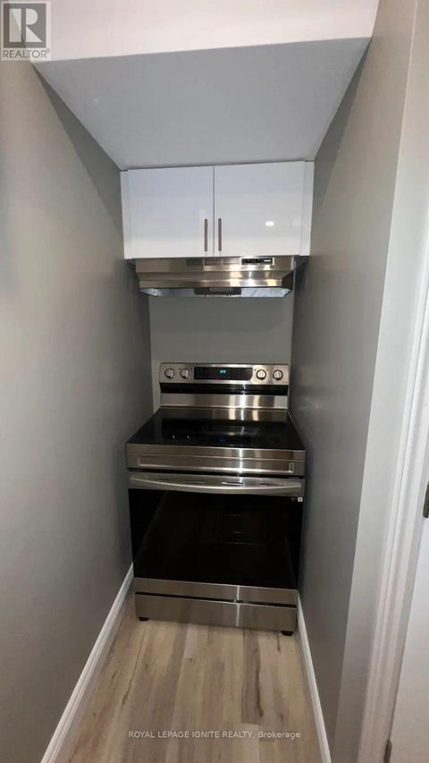 A small kitchen with a stainless steel oven and microwave.