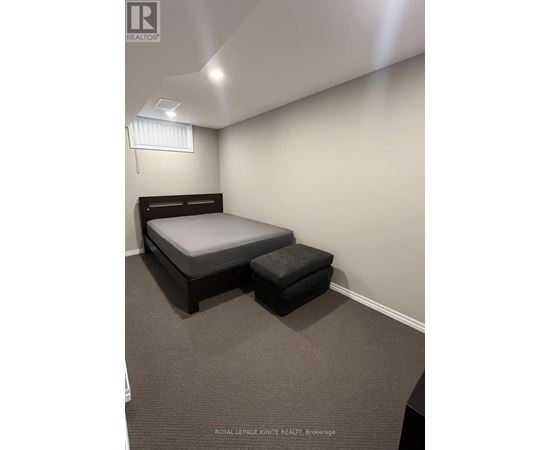 A bedroom with a bed and a bench in it.