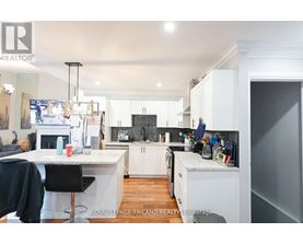 A well-lit kitchen with white cabinets and a large island.
