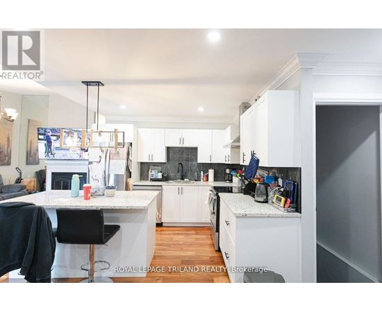 A well-lit kitchen with white cabinets and a large island.