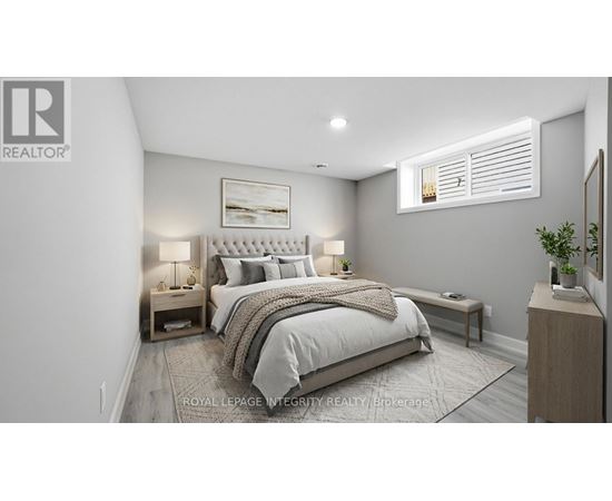 A bedroom with a large bed and a small nightstand with a lamp.