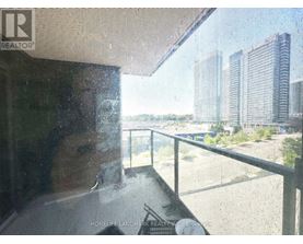 A view from inside a building looking out onto a balcony with a glass railing.