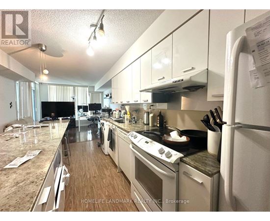 A kitchen with a refrigerator, stove, and oven.