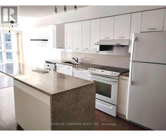 A kitchen with white cabinets and appliances.