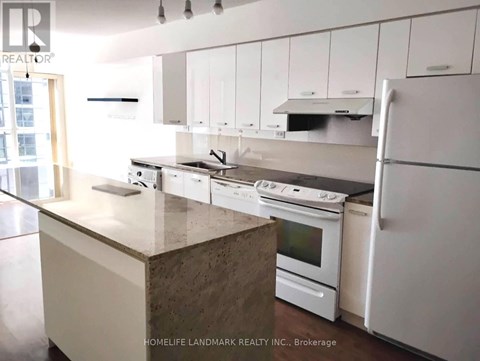 A kitchen with white cabinets and appliances.
