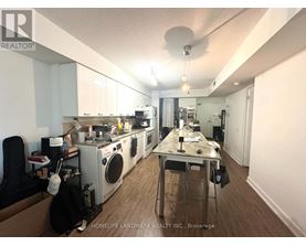 A kitchen with a table and chairs in the middle of it.