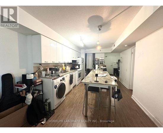 A kitchen with a table and chairs in the middle of it.