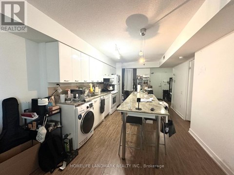 A kitchen with a table and chairs in the middle of it.