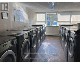 A laundromat with rows of washing machines.