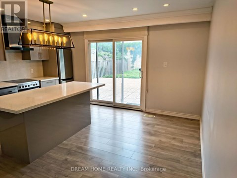 A kitchen with a counter top and a sliding glass door.