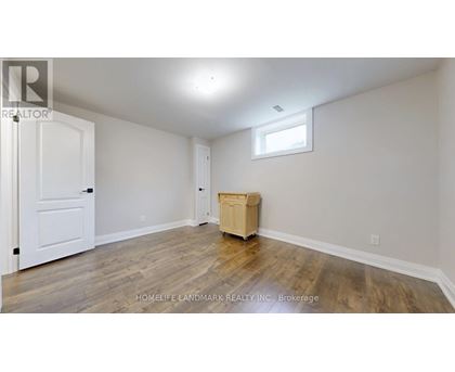 A room with a wooden floor and a white door.