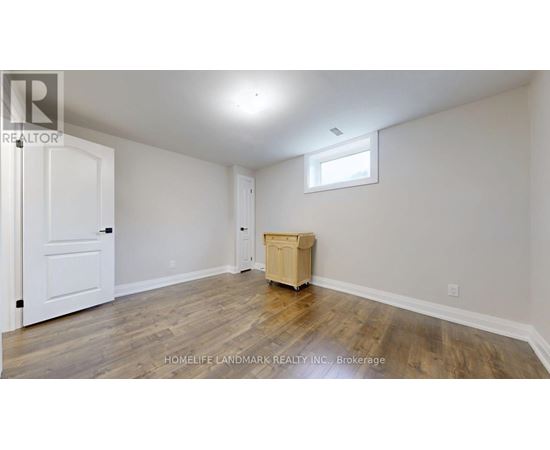 A room with a wooden floor and a white door.