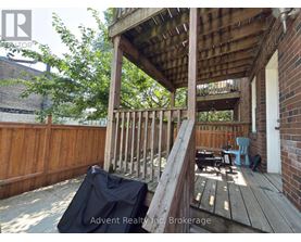 A wooden deck with a black tarp on it.