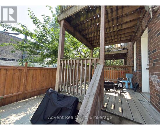 A wooden deck with a black tarp on it.