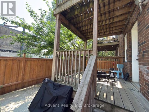 A wooden deck with a black tarp on it.