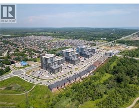 An aerial view of a residential area with a large building complex in the foreground.