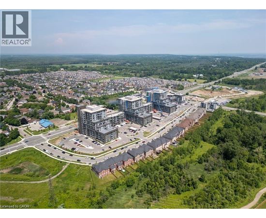 An aerial view of a residential area with a large building complex in the foreground.