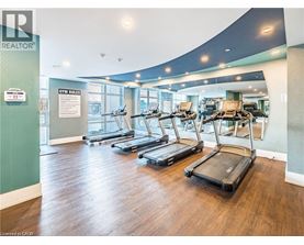 A gym with treadmills and a sign that says "GYM RULES".