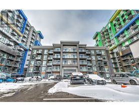 A parking lot with cars and buildings in the background.
