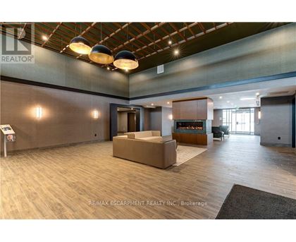 A spacious office lobby with a reception desk and a seating area.