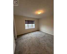 A room with a window and carpeted floor.