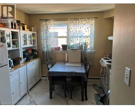 A kitchen with a table and chairs in the middle of the room.