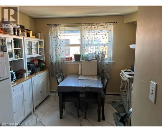 A kitchen with a table and chairs in the middle of the room.
