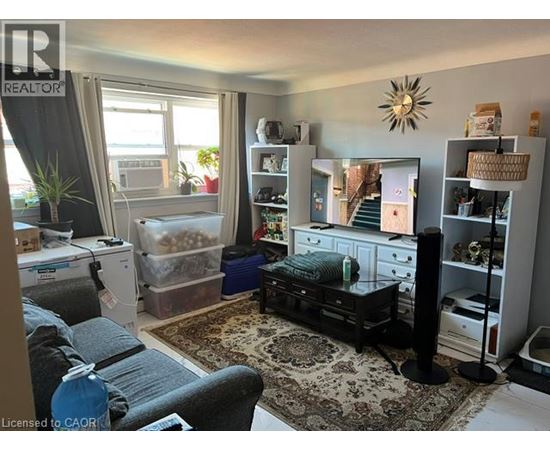 A living room with a grey couch and a black coffee table.