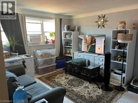 A living room with a grey couch and a black coffee table.