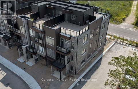 An aerial view of a multi-story building with balconies and a road in front.