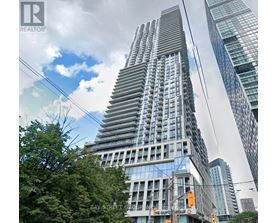 A tall building with a glass facade is the focal point of the image.