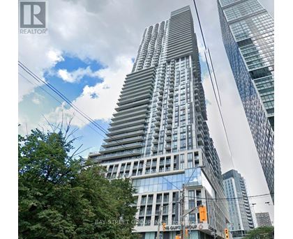 A tall building with a glass facade is the focal point of the image.