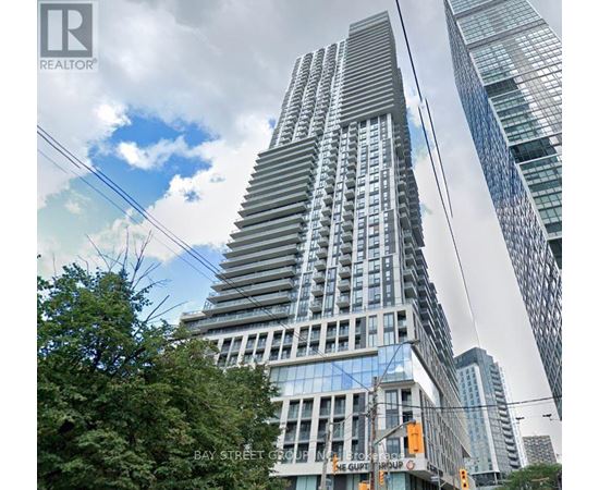 A tall building with a glass facade is the focal point of the image.