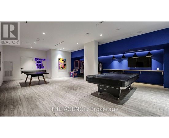 A room with a pool table and a billiard table.